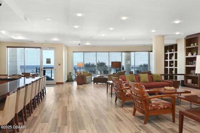 living room with light wood finished floors and recessed lighting