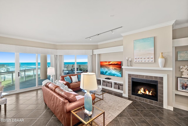 tiled living area with crown molding and a tiled fireplace