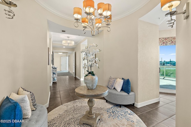 hallway with crown molding, baseboards, tile patterned flooring, and an inviting chandelier