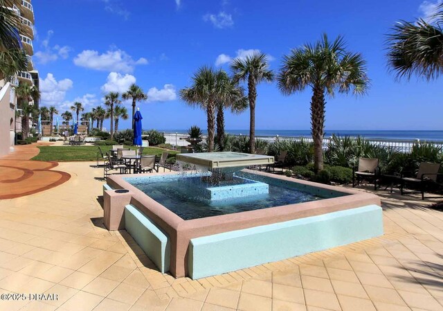 view of pool featuring a patio and a water view