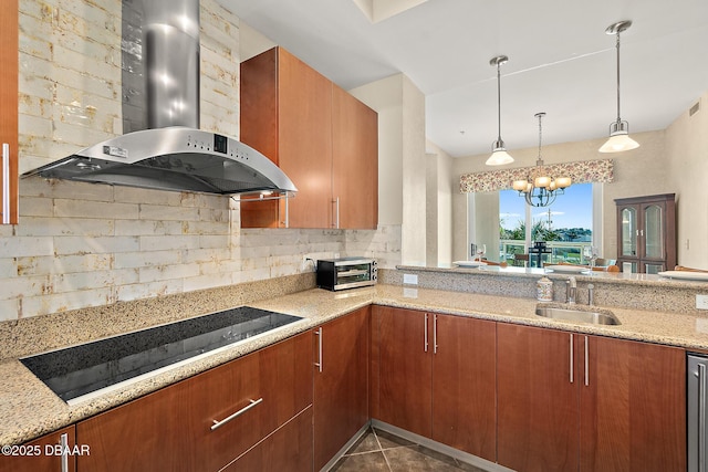 kitchen featuring decorative backsplash, wall chimney exhaust hood, light stone countertops, black electric cooktop, and a sink