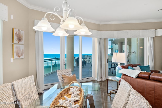 dining space featuring a chandelier, a water view, and crown molding