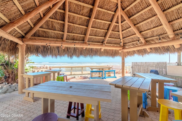 wooden terrace featuring a water view and a gazebo