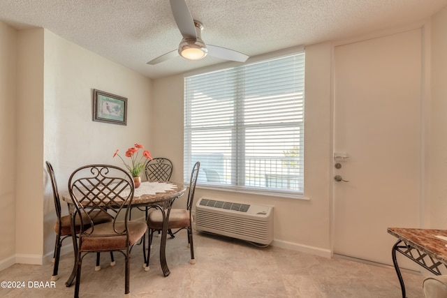 dining room featuring a wall mounted AC, a textured ceiling, and ceiling fan