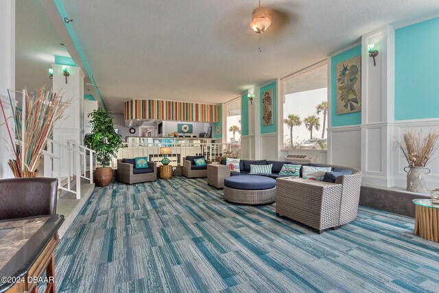 living room with a textured ceiling and carpet flooring