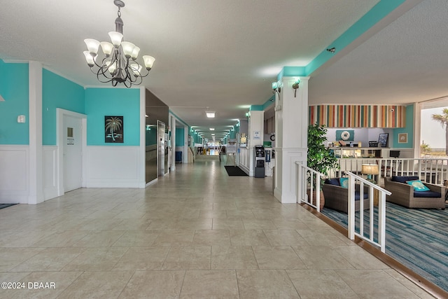 interior space featuring a textured ceiling and a notable chandelier