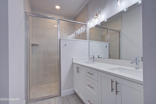 bathroom with a shower with door and vanity