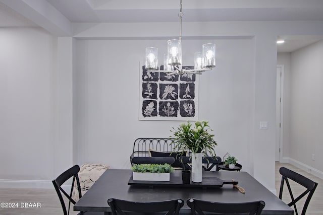 dining area with an inviting chandelier and hardwood / wood-style flooring