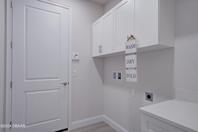 washroom featuring light hardwood / wood-style floors, washer hookup, cabinets, and hookup for an electric dryer