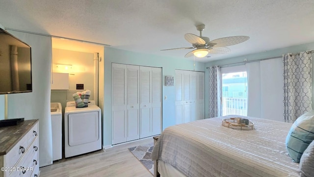 2820 Ocean Shore Blvd Unit 28, Ormond Beach, FL 32176 - bedroom with independent washer and dryer, light wood-type flooring, two closets, a ceiling fan, and a textured ceiling