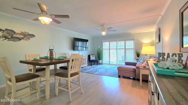 2820 Ocean Shore Blvd Unit 28, Ormond Beach, FL 32176 - dining area featuring crown molding, light wood-style floors, and a ceiling fan