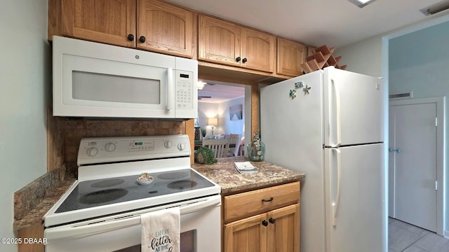2820 Ocean Shore Blvd Unit 28, Ormond Beach, FL 32176 - kitchen with white appliances and light tile patterned floors