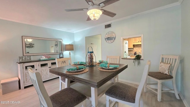 2820 Ocean Shore Blvd Unit 28, Ormond Beach, FL 32176 - dining room with light wood-style floors, crown molding, and a ceiling fan