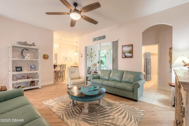 living room with ceiling fan and light wood-type flooring