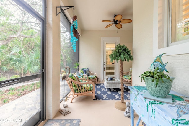 sunroom featuring ceiling fan