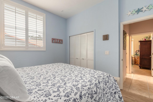 tiled bedroom with a closet