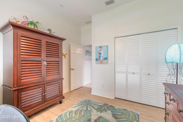 bedroom featuring light hardwood / wood-style floors and a closet