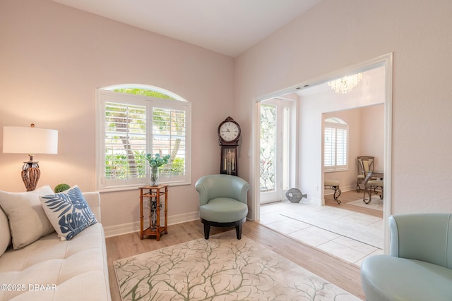 living area with a notable chandelier and light hardwood / wood-style flooring