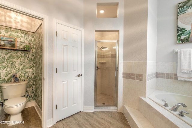 bathroom featuring shower with separate bathtub, hardwood / wood-style floors, and toilet