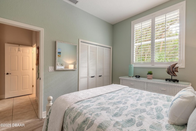 tiled bedroom with a closet