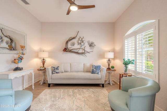 living room with ceiling fan and light wood-type flooring