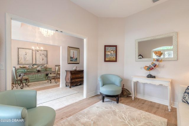 living area featuring an inviting chandelier and wood-type flooring