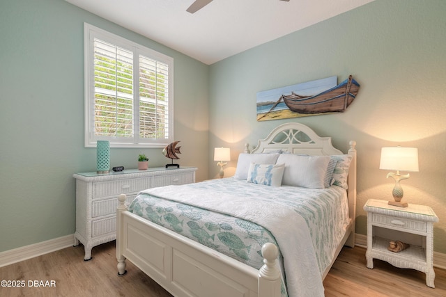 bedroom with light hardwood / wood-style floors and ceiling fan