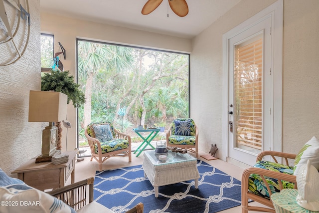 sunroom / solarium featuring ceiling fan