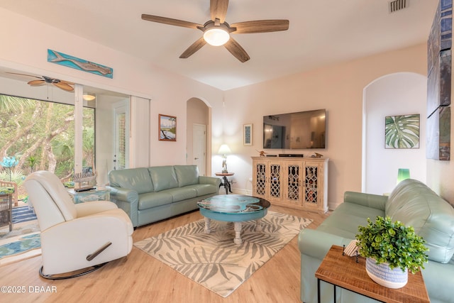 living room with hardwood / wood-style floors and ceiling fan