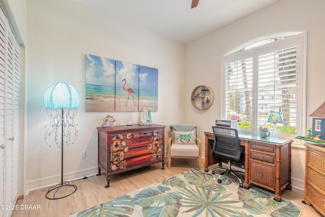 home office with light hardwood / wood-style floors