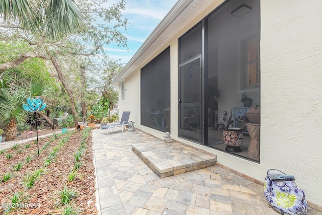 view of patio / terrace featuring a sunroom