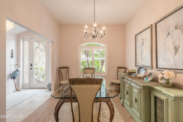 dining space with an inviting chandelier and light tile patterned floors