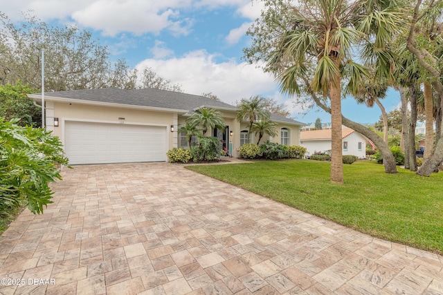 ranch-style house featuring a garage and a front lawn