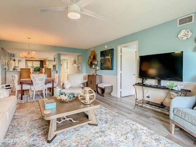 4 Oceans W Blvd Unit 307D, Daytona Beach Shores, FL 32118 - living area with wood finished floors, a ceiling fan, wainscoting, and a chandelier