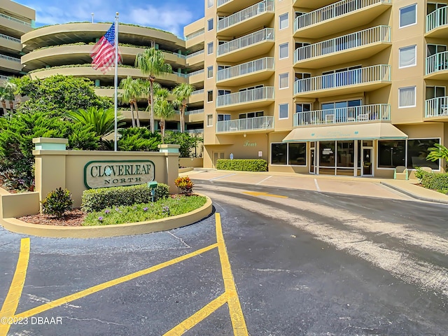 4 Oceans W Blvd Unit 307D, Daytona Beach Shores, FL 32118 - view of apartment building / complex featuring uncovered parking