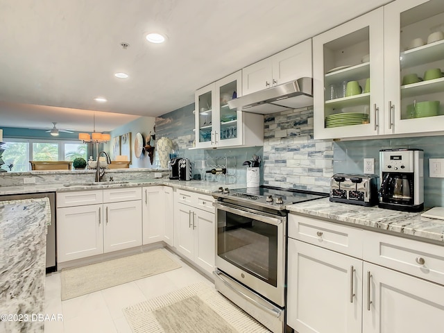 kitchen with light tile patterned floors, stainless steel electric range oven, light stone countertops, sink, and white cabinets