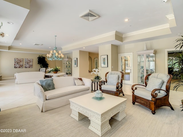 living room featuring an inviting chandelier, crown molding, and a tray ceiling