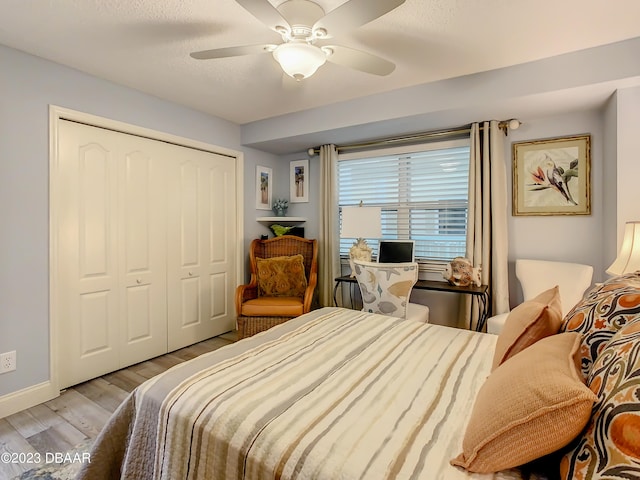 bedroom with ceiling fan, a closet, and light wood-type flooring