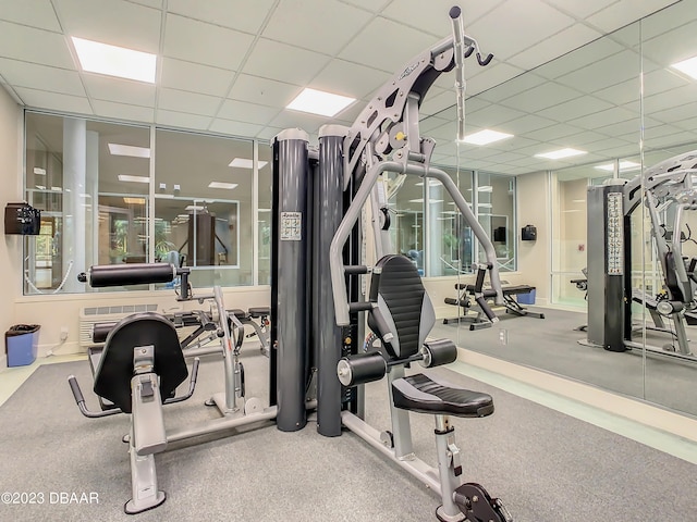 workout area featuring a paneled ceiling