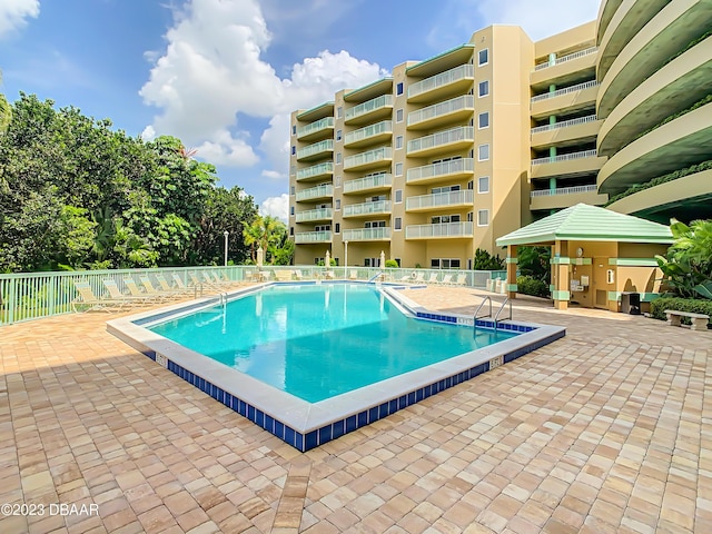 4 Oceans W Blvd Unit 307D, Daytona Beach Shores, FL 32118 - community pool with fence and a patio area