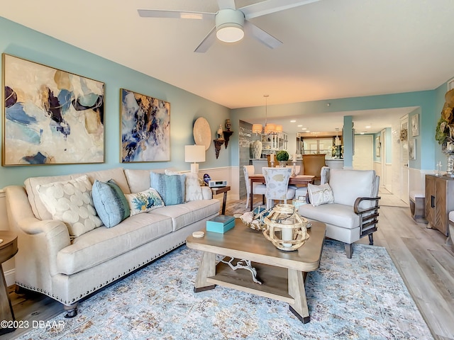 living room featuring light wood-type flooring and ceiling fan