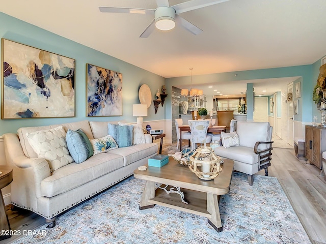 4 Oceans W Blvd Unit 307D, Daytona Beach Shores, FL 32118 - living room featuring wood finished floors, ceiling fan, a chandelier, and wainscoting