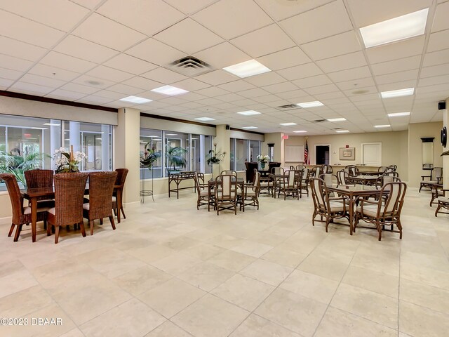 dining area with a paneled ceiling