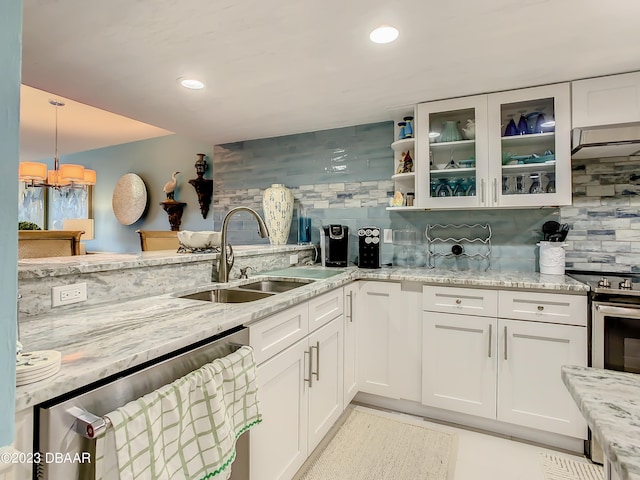 kitchen with white cabinetry, decorative backsplash, appliances with stainless steel finishes, and sink