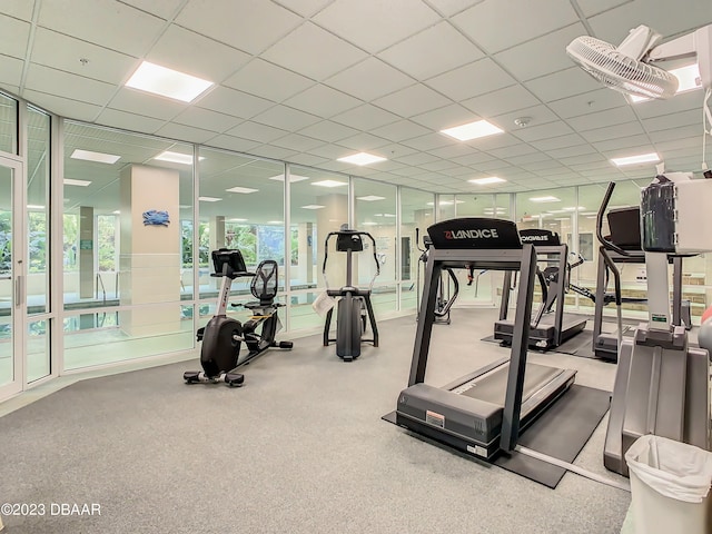 gym with a paneled ceiling