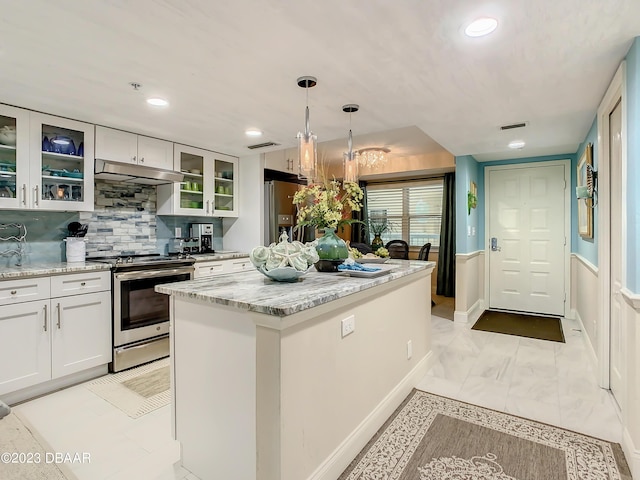 4 Oceans W Blvd Unit 307D, Daytona Beach Shores, FL 32118 - kitchen featuring appliances with stainless steel finishes, under cabinet range hood, white cabinets, pendant lighting, and light stone countertops