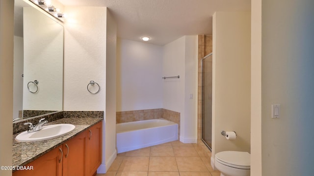 full bathroom featuring shower with separate bathtub, vanity, toilet, tile patterned floors, and a textured ceiling