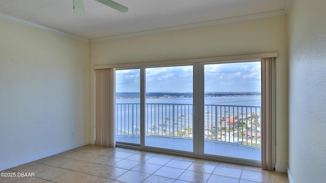 spare room featuring light tile patterned flooring, ornamental molding, ceiling fan, and a water view