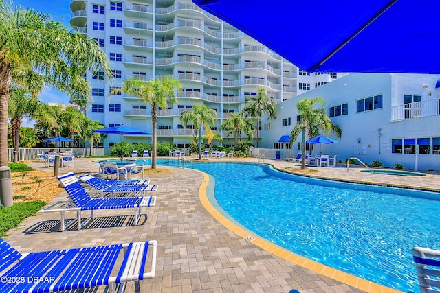 view of pool featuring a patio and a community hot tub