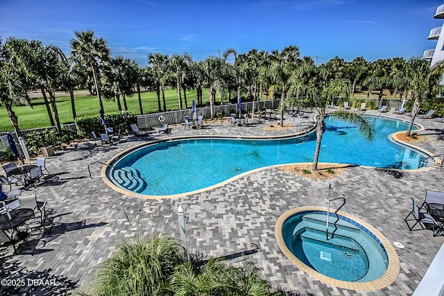 view of pool featuring a hot tub and a patio area